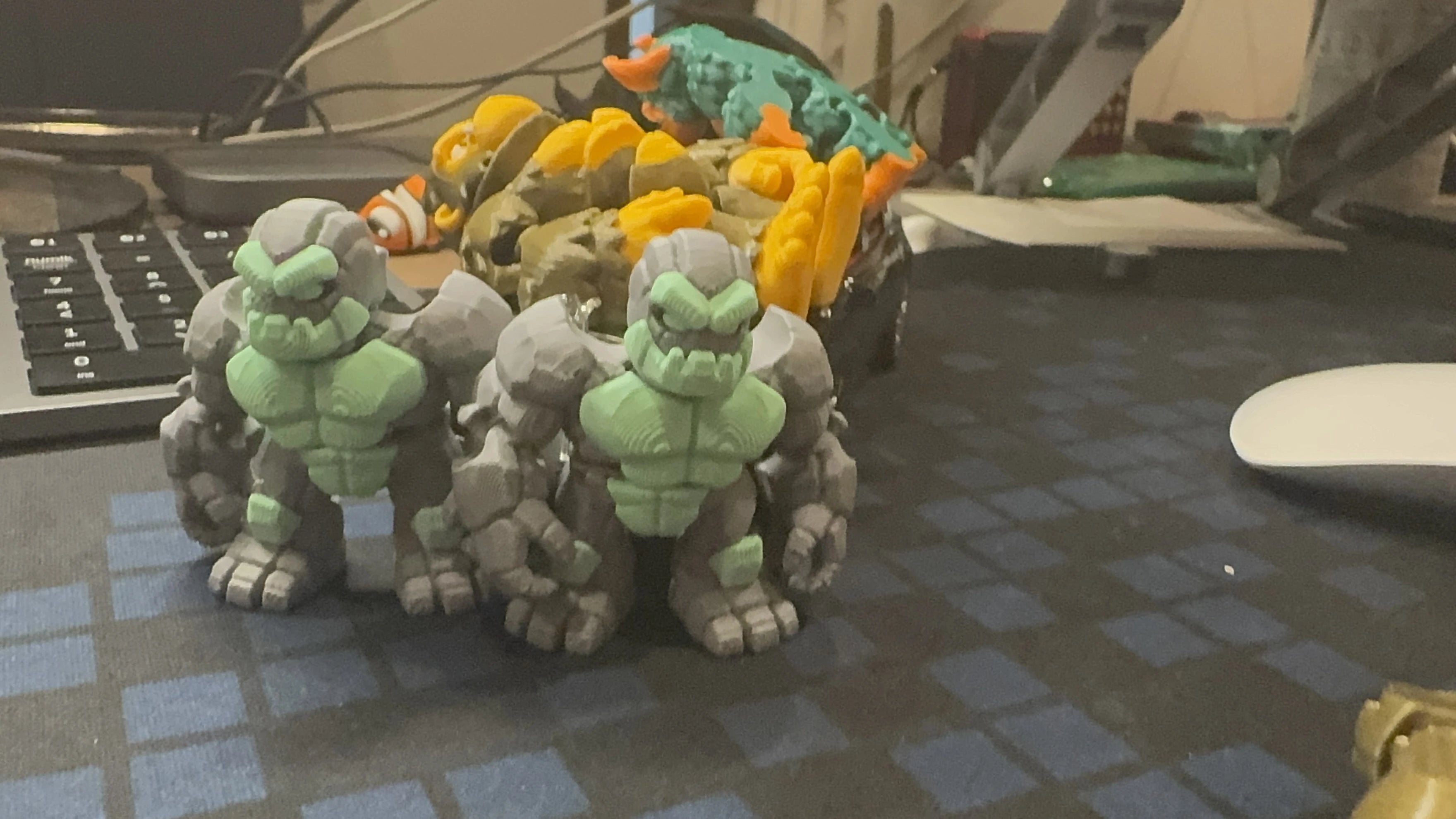 WiggleNest articulated stone golem 3D printed toy in gray and green PLA, professionally displayed with eco-friendly materials and premium craftsmanship. Durable collectible flexi toy, designed and made in Malaysia. 