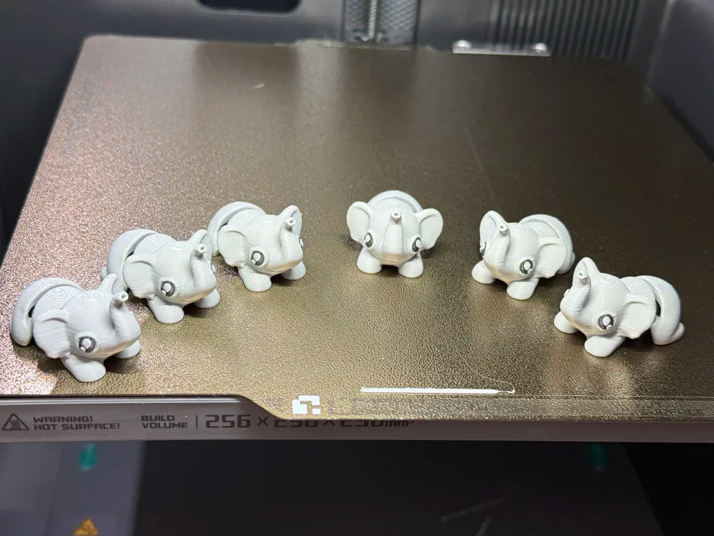 Cute Tiny Flexy Elephant 3D printed articulated animal toy, a fun pocket-sized fidget for kids, collectors, party gifts and sensory play by Wigglenest 3D.